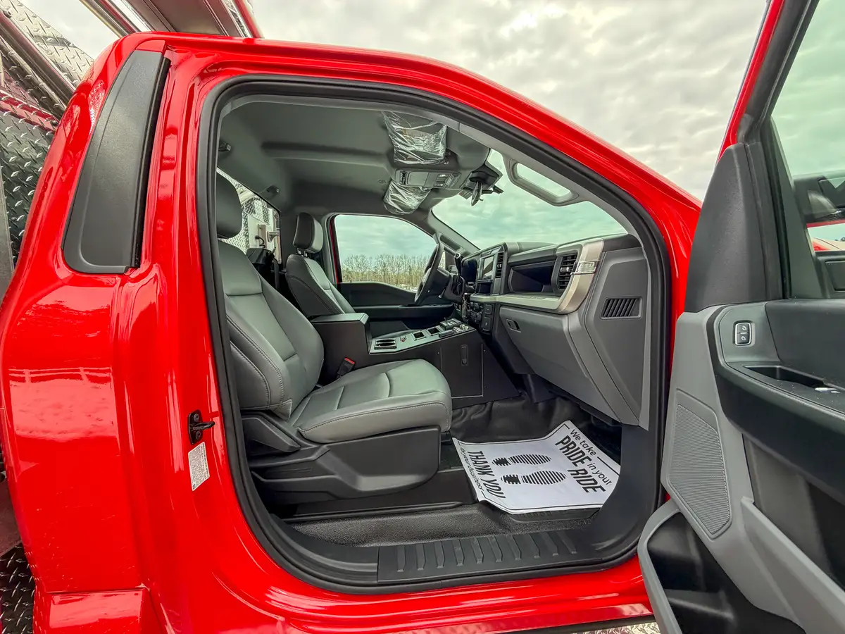 Front seat and center console viewed from driver-side doorway.